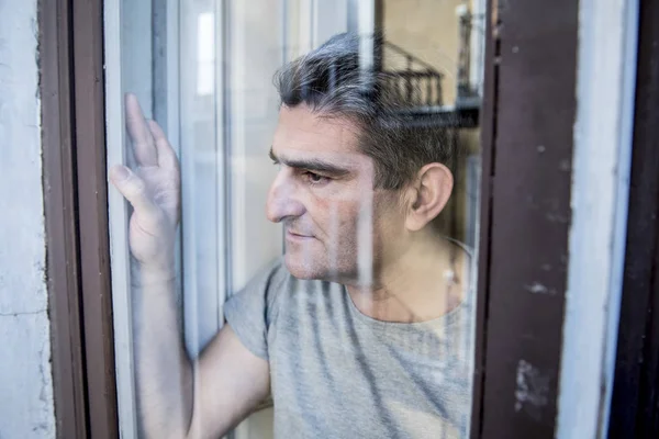 Close up portrait of sad and depressed 40s man looking through w — Stock Photo, Image