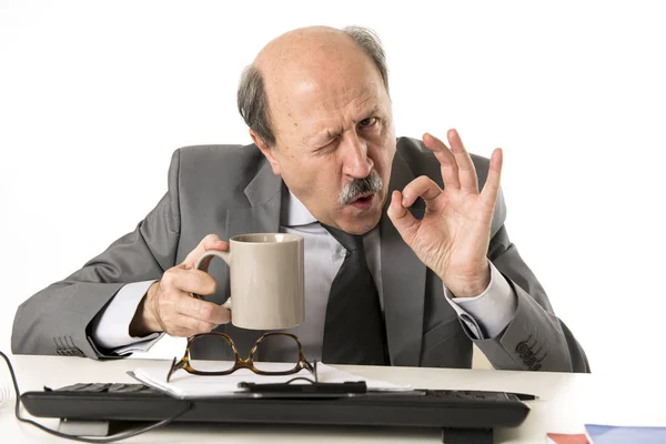 Friendly 60s bald senior business man holding coffee cup drinkin — Stock Photo, Image
