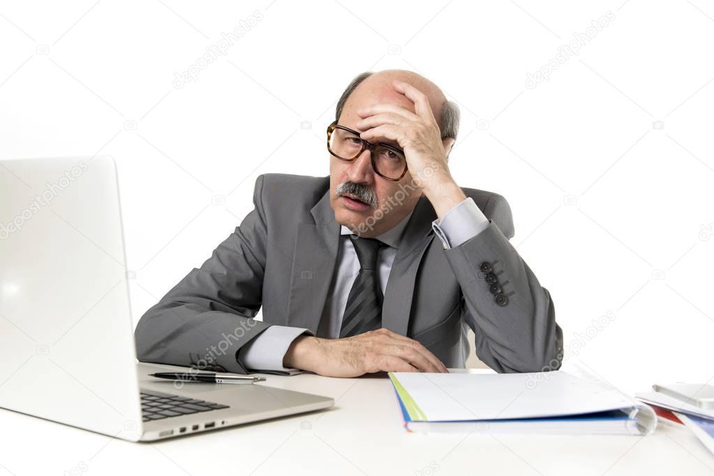 mature business man with bald head on his 60s working stressed and frustrated at office computer laptop desk looking tired 