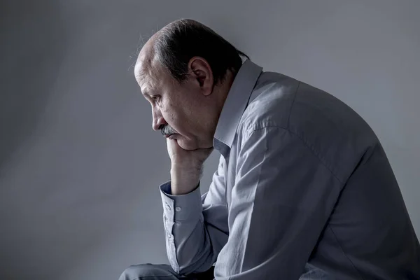 head portrait of senior mature old man on his 60s looking sad and worried suffering pain and depression in sadness face expression