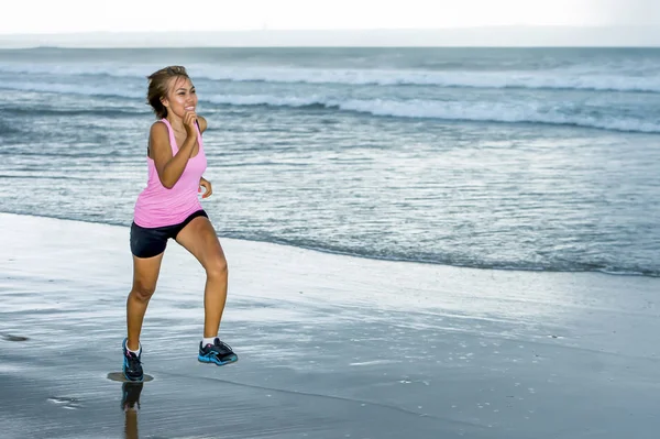 Junge attraktive und fitte asiatische Sportläuferin, die am Strand am Meer läuft und glücklich in Fitness lächelt — Stockfoto