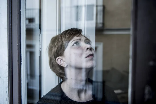 Dramatic close up portrait of young beautiful woman thinking and  feeling sad suffering depression at home window looking depressed — Stock Photo, Image