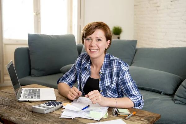 happy woman banking and accounting home monthly and credit card expenses with computer laptop doing paperwork