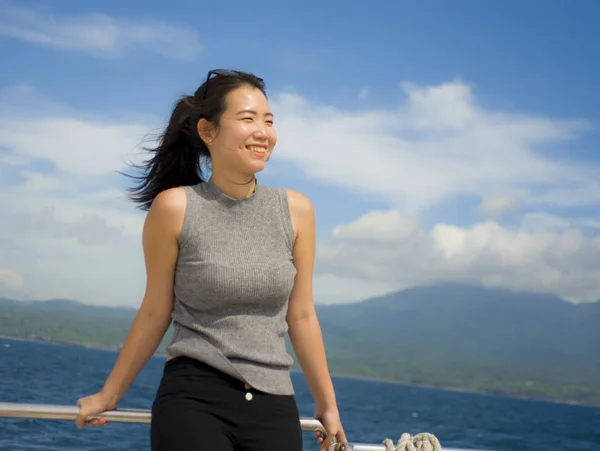 Young attractive and happy Asian Chinese woman on excursion ship or ferry  enjoying sea breeze on summer holiday sea boat trip — Stock Photo, Image