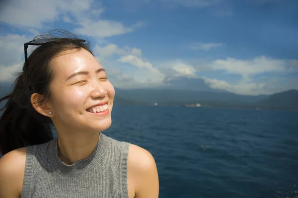 Young beautiful and sweet Asian Chinese woman smiling happy enjoying sea breeze at tropical ocean landscape — Stock Photo, Image