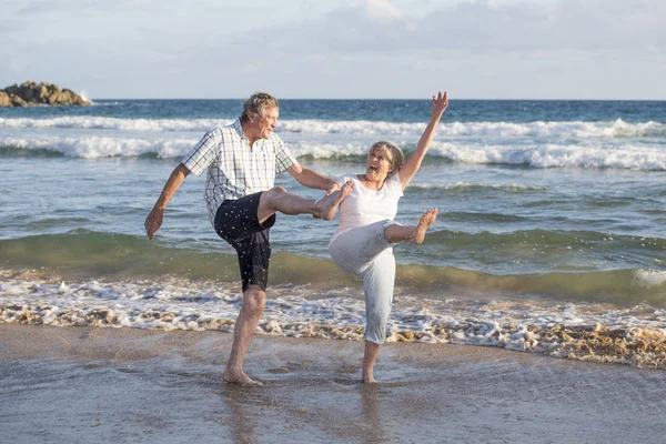 Милая взрослая пара в возрасте 60-70 лет на пенсии ходьба счастливая и расслабленная на берегу моря в романтическое старение вместе — стоковое фото