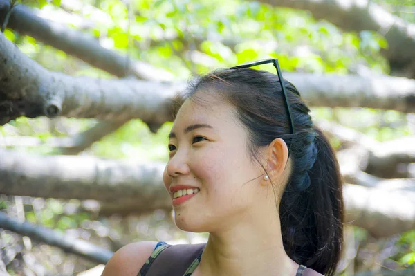 Young pretty and happy backpacker Asian Chinese woman trekking and hiking excursion trip on tropical mountain enjoying nature smiling — Stock Photo, Image