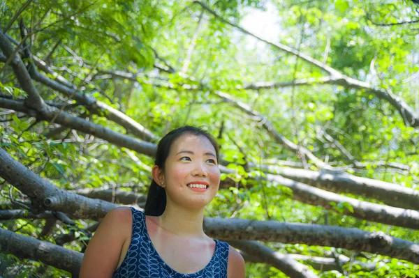 Young pretty and happy Asian Chinese woman taking a walk excursion trip on tropical mountain enjoying nature smiling cheerful in holiday — Stock Photo, Image