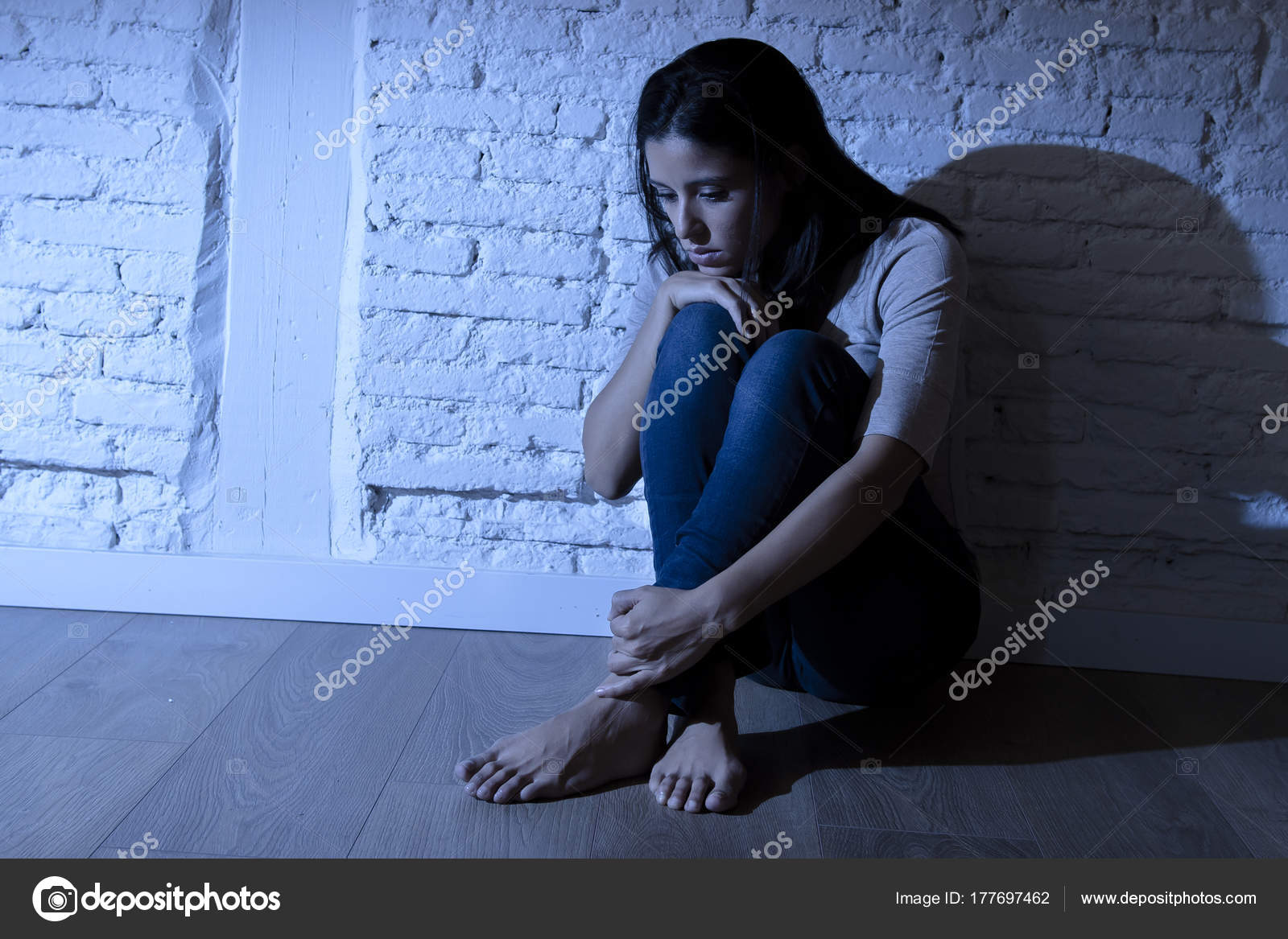 Lonely Young Attractive Hispanic Woman Sitting At Home Floor