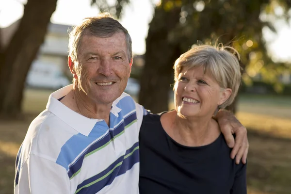 Portrait of American senior beautiful and happy mature couple around 70 years old showing love and affection smiling together in the park — Stock Photo, Image