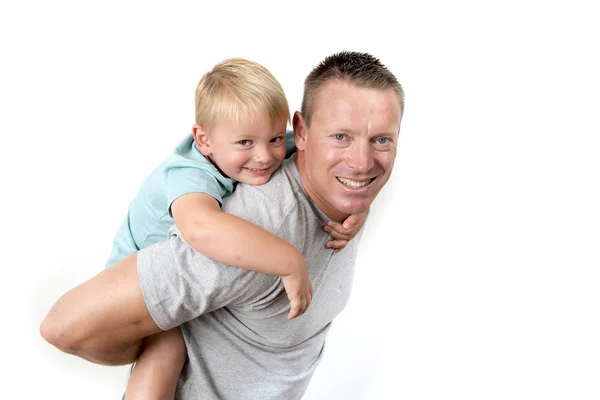 Joven atractivo y atlético padre llevando en su espalda joven hermoso y rubio hijo divertirse juntos posando aislado sobre fondo blanco — Foto de Stock