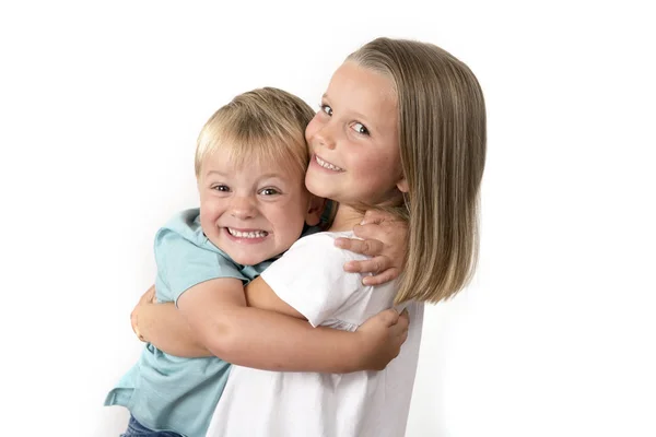 7 years old adorable blond happy girl posing with her little 3 years old brother smiling cheerful isolated on white background — Stock Photo, Image