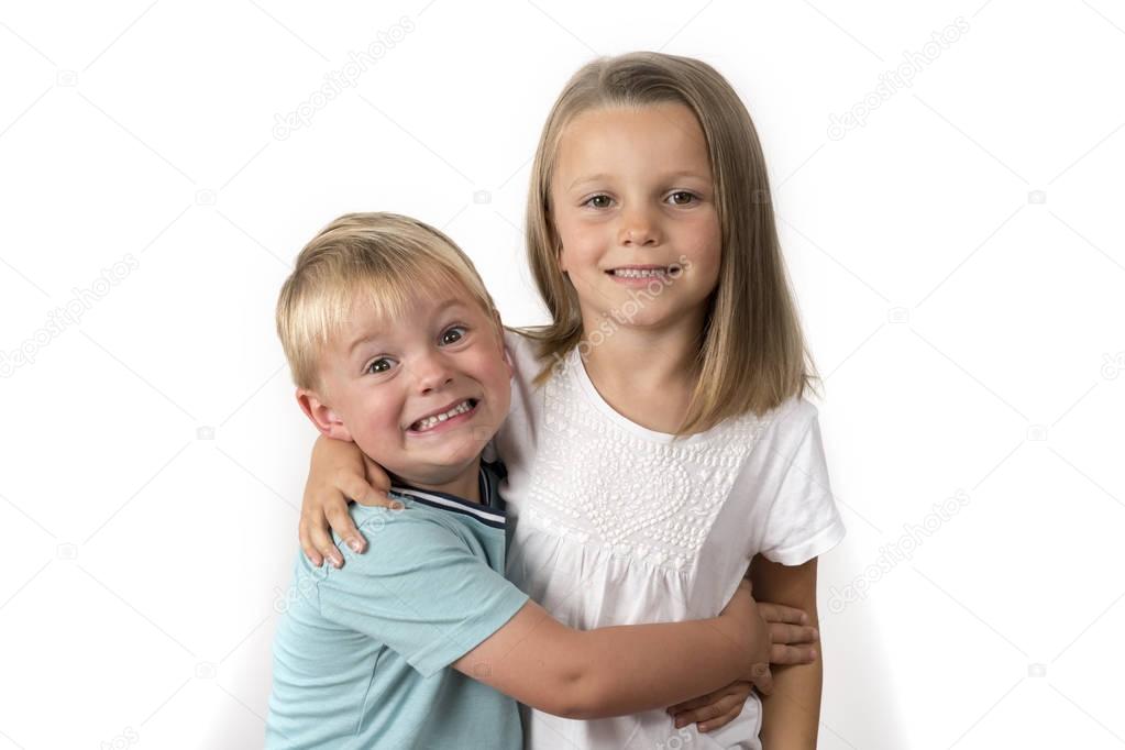 7 years old adorable blond happy girl posing with her little 3 years old brother smiling cheerful isolated on white background
