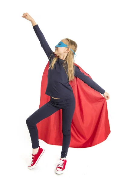 7 or 8 years old young female schoolgirl child in super hero costume performing happy and excited isolated on white background