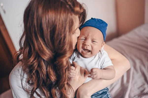 Close Portrait Happy Young Mom Holding Her Crying Baby Blue — Stock Photo, Image