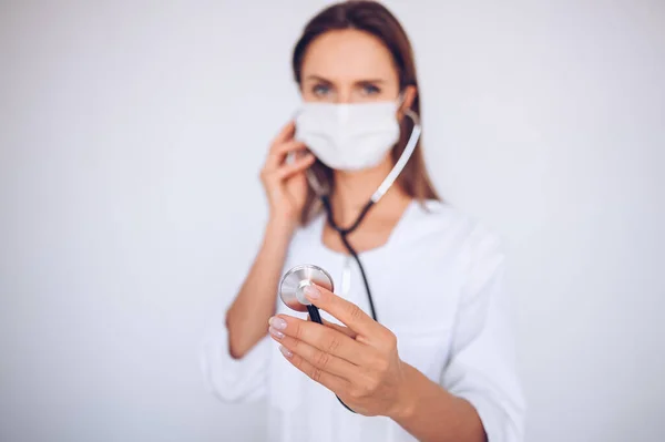 Woman doctor nurse wearing protective mask and stethoscope for check breathing, corona virus prevention, hygiene to stop spreading coronavirus. Avoid contaminating Corona virus Covid-19 concept