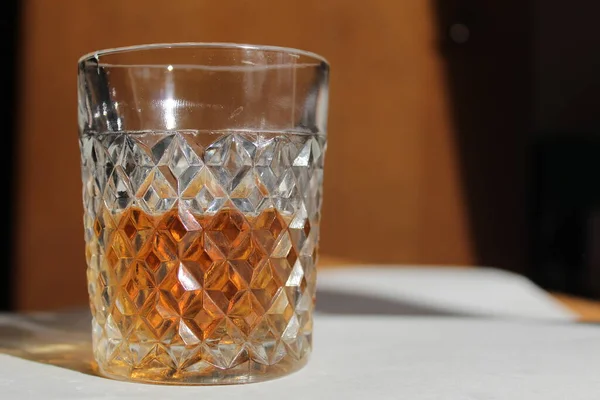 Fluted Glass Cognac Brandy Whiskey White Dark Background Illuminated Bright — Stock Photo, Image