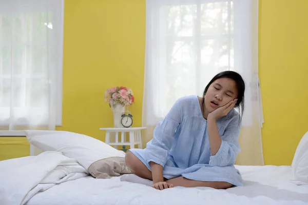 Young teenage girl stretching in bed after wake up — Stock Photo, Image