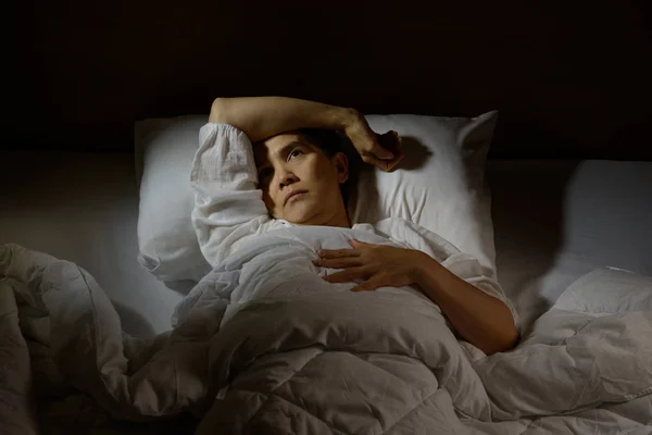 Donna con insonnia sdraiata a letto ad occhi aperti — Foto Stock