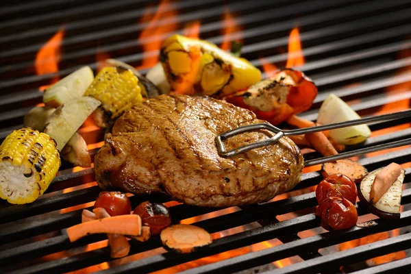 Carne grelhada / bife com legumes na grelha flamejante — Fotografia de Stock