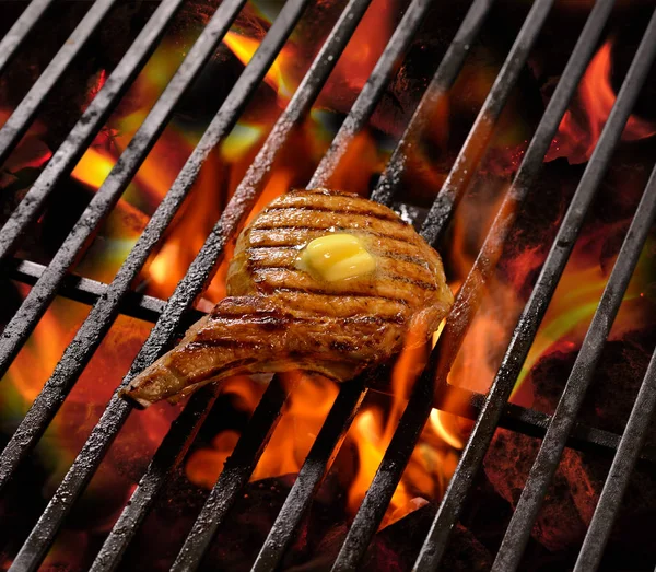 Grilled meat /steak with butter on top on the flaming grill — Stock Photo, Image