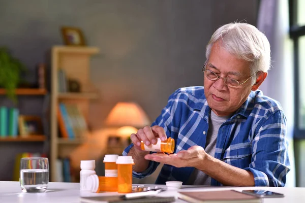 Asian Senior Man Taking Medicine Home — Stock Photo, Image