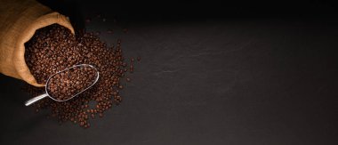  Coffee beans in burlap sack on black background clipart