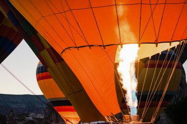 Flying hot air balloons preparing for festival in Cappadocia, Turkey.