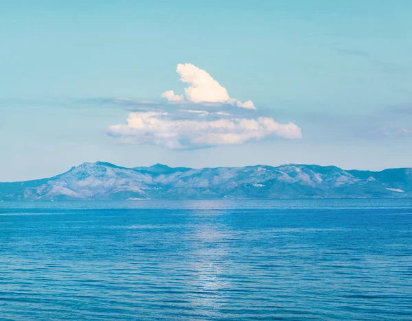 以平静的水和高山为背景的海景 — 图库照片