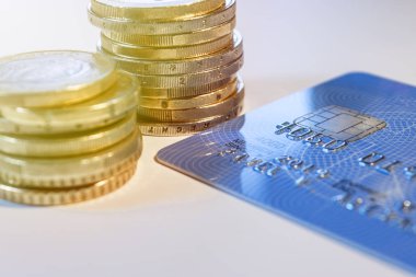 Credit card with coins on table