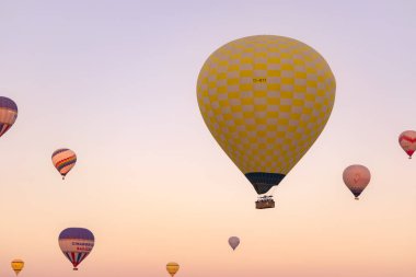 Flying hot air balloons high in the sky on festival in Cappadocia, Turkey.