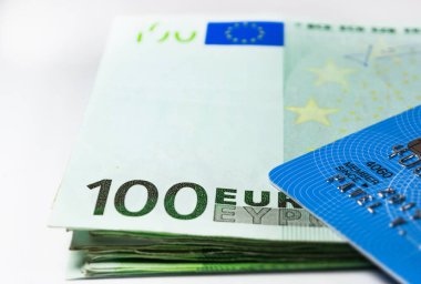 Euro banknotes and credit card on table