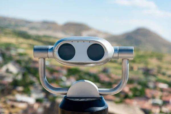 Observation binoculars close up, Uchisar Castle viewpoint. Copy space.