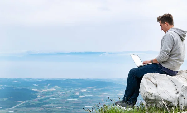 Young Man Laptop Sitting Top Mountain Working Online Cellular Network — Stock Photo, Image