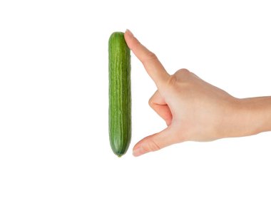 Man penis size concept, hand measuring a small cucumber, isolated on white background. clipart