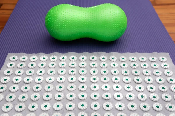 Acupressure mat with Small Peanut Shaped Exercise Ball. Alternative therapy massage concept