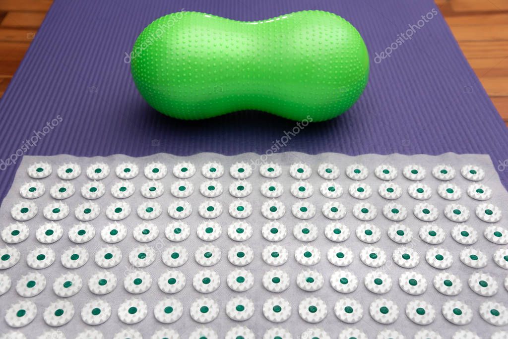 Acupressure mat with Small Peanut Shaped Exercise Ball. Alternative therapy massage concept