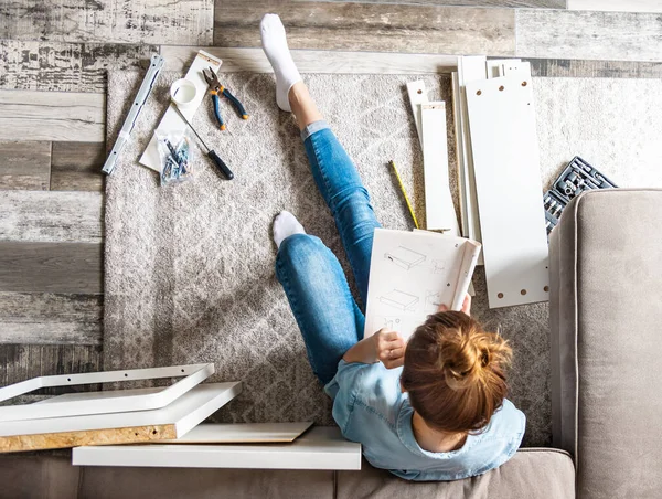 Concentrated Young Woman Reading Instructions Assemble Furniture Home Living Room — Stock Photo, Image