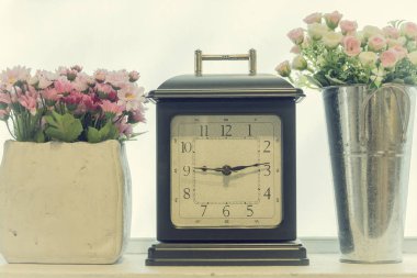 Retro çalar saat ile bir vazo çiçek iç 