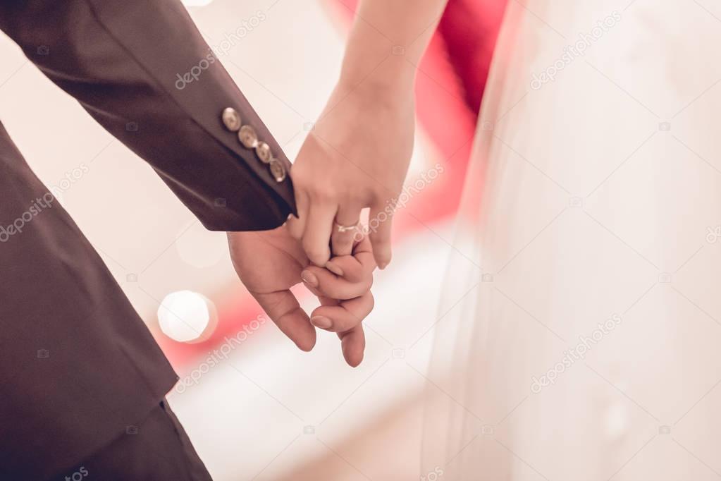 Hands of bride and groom with rings Interpretation of love. Wedd