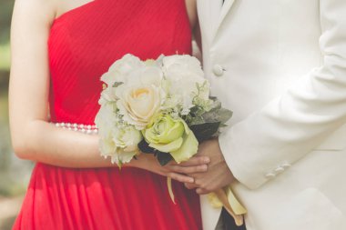Gelin ve damat birbirlerine kucaklayan f bir buket ile evli
