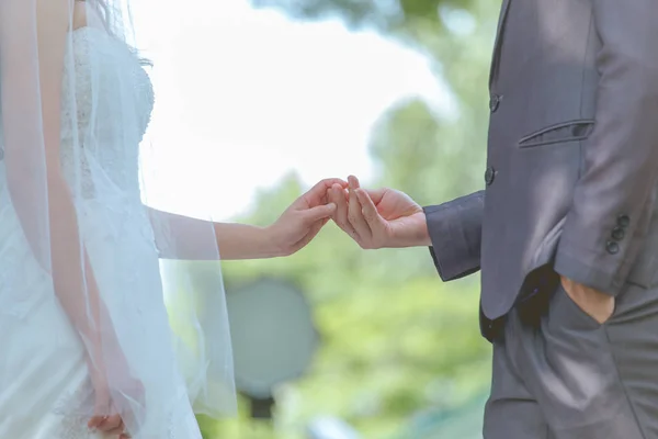 Married bride and groom holding hands as a symbol of love — Stock Photo, Image