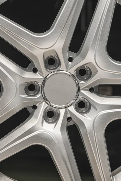 alloy wheel silver, rim new car wheel on a black background close up vertical concept