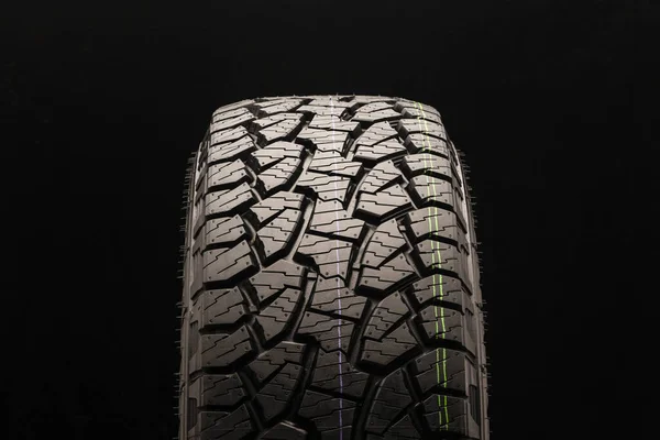 mud all terrain tires for SUVs on a black background close-up, front view of the wheel, the tread can be clearly seen