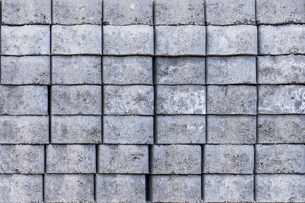 grey background, bricks laid on a pallet