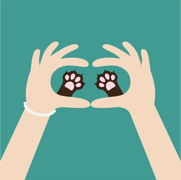 Ruce držící cute pet tlapky — Stockový vektor