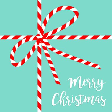 Mutlu noeller. Mavi arka planda kırmızı beyaz kurdele düğümü. Çubuk şeker renginde. Şirin bir Noel süsü. Düz dizayn. İzole edilmiş.