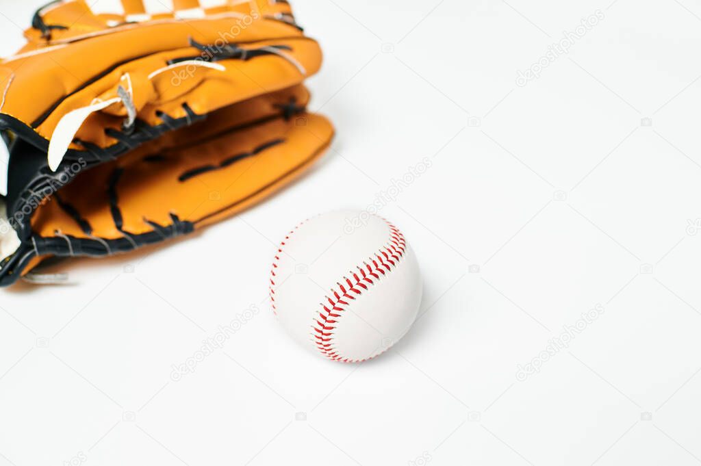 Ball and baseball glove on white background