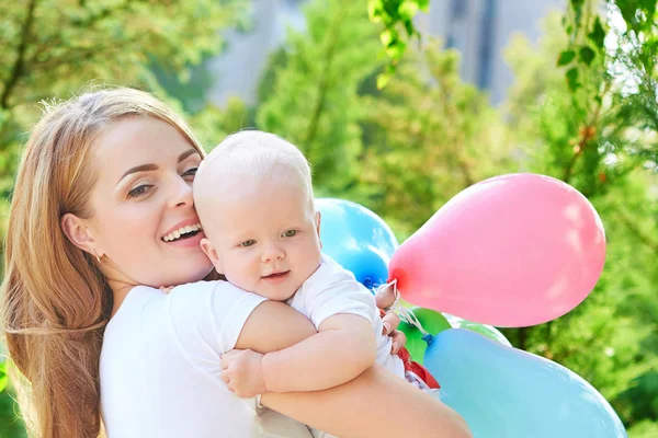 Happy beautiful mother and baby daughter or son — Stock Photo, Image