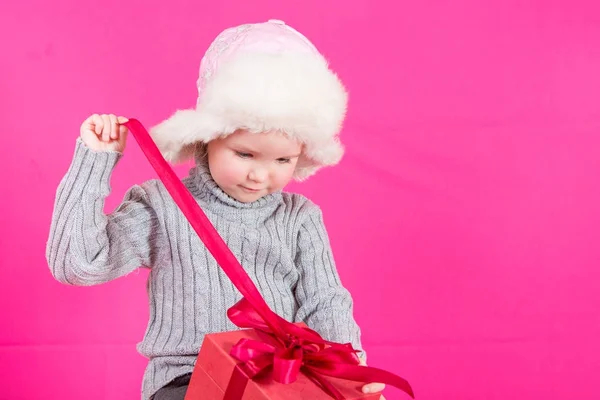 Beautiful little girl with a gift — Stock Photo, Image